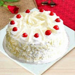 A decadent Amarula White Forest Cake with layers of vanilla sponge, infused with Amarula liqueur, white chocolate mousse, and cherries, as a sweet treat by Cake Gurus Ruaka Nairobi with deliveries in Nairobi and its environs.