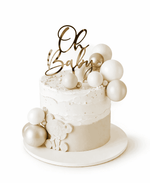 White baby shower cake with 'Oh Baby' topper and balloons on a white background. Cake Gurus, Ruaka, Nairobi Same day Delivery