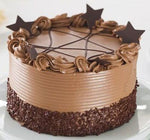Tiramisu Cake with creamy frosting and decorative chocolate stars on top as a sweet treat by Cake Gurus Ruaka Nairobi with deliveries in Nairobi and its environs.