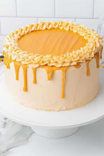 A butterscotch cake with a creamy beige frosting and a caramel-like drip,  as a sweet treat by Cake Gurus Ruaka Nairobi with deliveries in Nairobi and its environs.