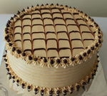 Choconilla cake with chocolate layers, topped with a grid of chocolate pieces and surrounded by vanilla frosting  as a sweet treat by Cake Gurus Ruaka Nairobi with deliveries in Nairobi and its environs.