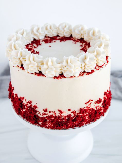 A red velvet cake with cream cheese frosting , with a decorative border of red velvet crumbs around the base,  as a sweet treat by Cake Gurus Ruaka Nairobi with deliveries in Nairobi and its environs.