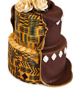 Three-tiered cake with Kente cloth design and chocolate icing on a white background