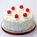 A white forest cake with light vanilla sponge and white chocolate mousse, garnished with cherries on top,  as a sweet treat by Cake Gurus Ruaka Nairobi with deliveries in Nairobi and its environs.