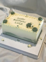 A rectangular zucchini cake with white icing and decorated with green floral designs,  as a sweet treat by Cake Gurus Ruaka Nairobi with deliveries in Nairobi and its environs